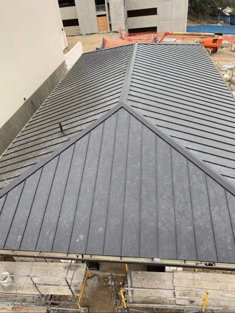 Commercial metal roof construction with crane equipment in Edgerton