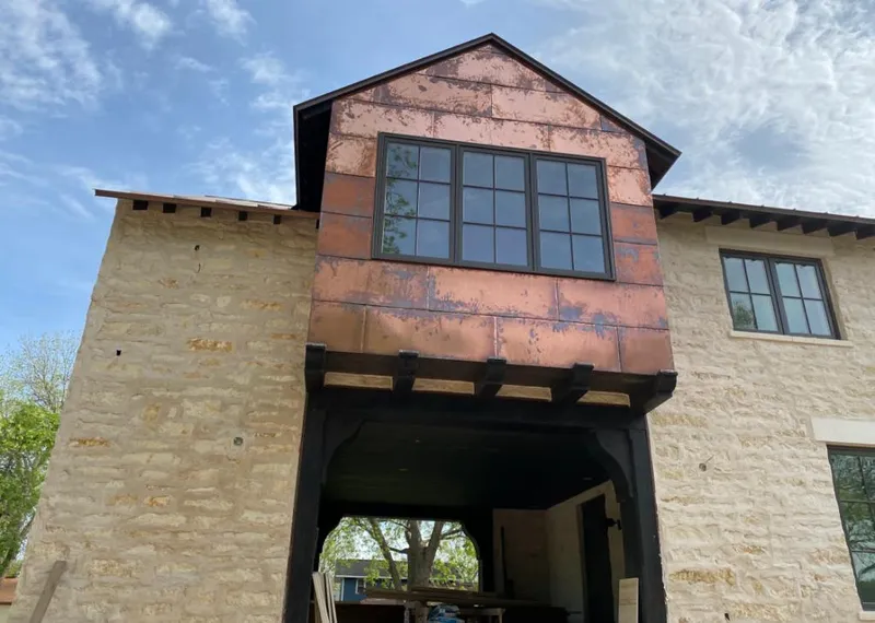 Copper metal panel facade on a stone building for Skylight Installation in Edgerton